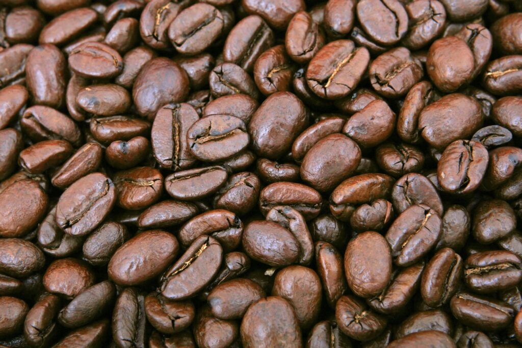 A close-up shot of shiny roasted coffee beans, perfect for caffeine lovers.