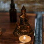 Buddha statue with candles creating a serene spa atmosphere, ideal for relaxation and mindfulness.